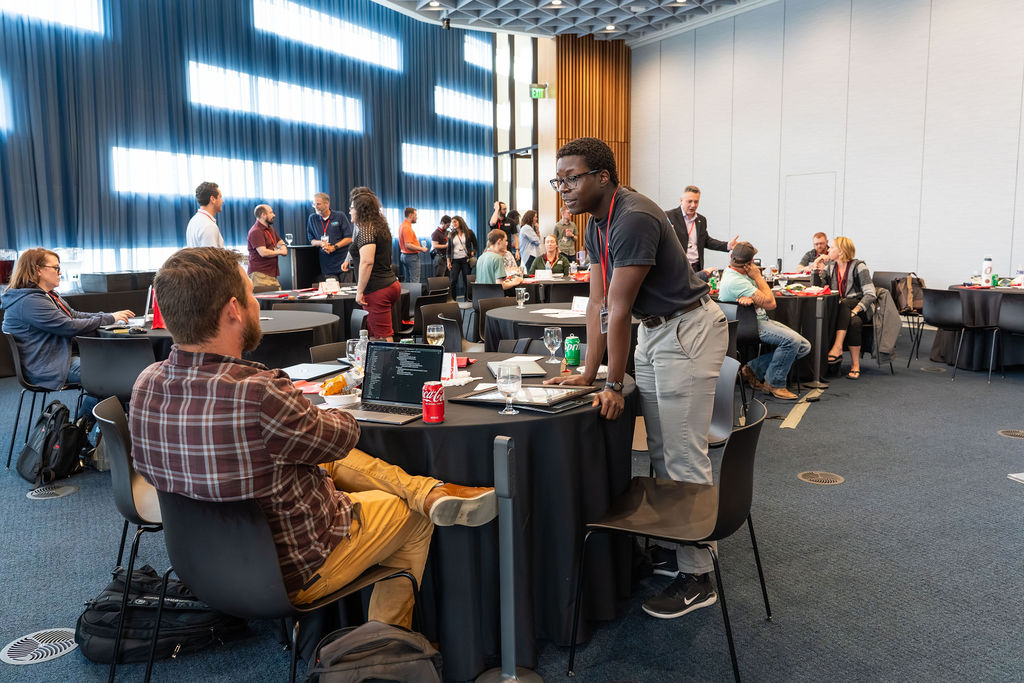 Attendees connecting at round tables between sessions