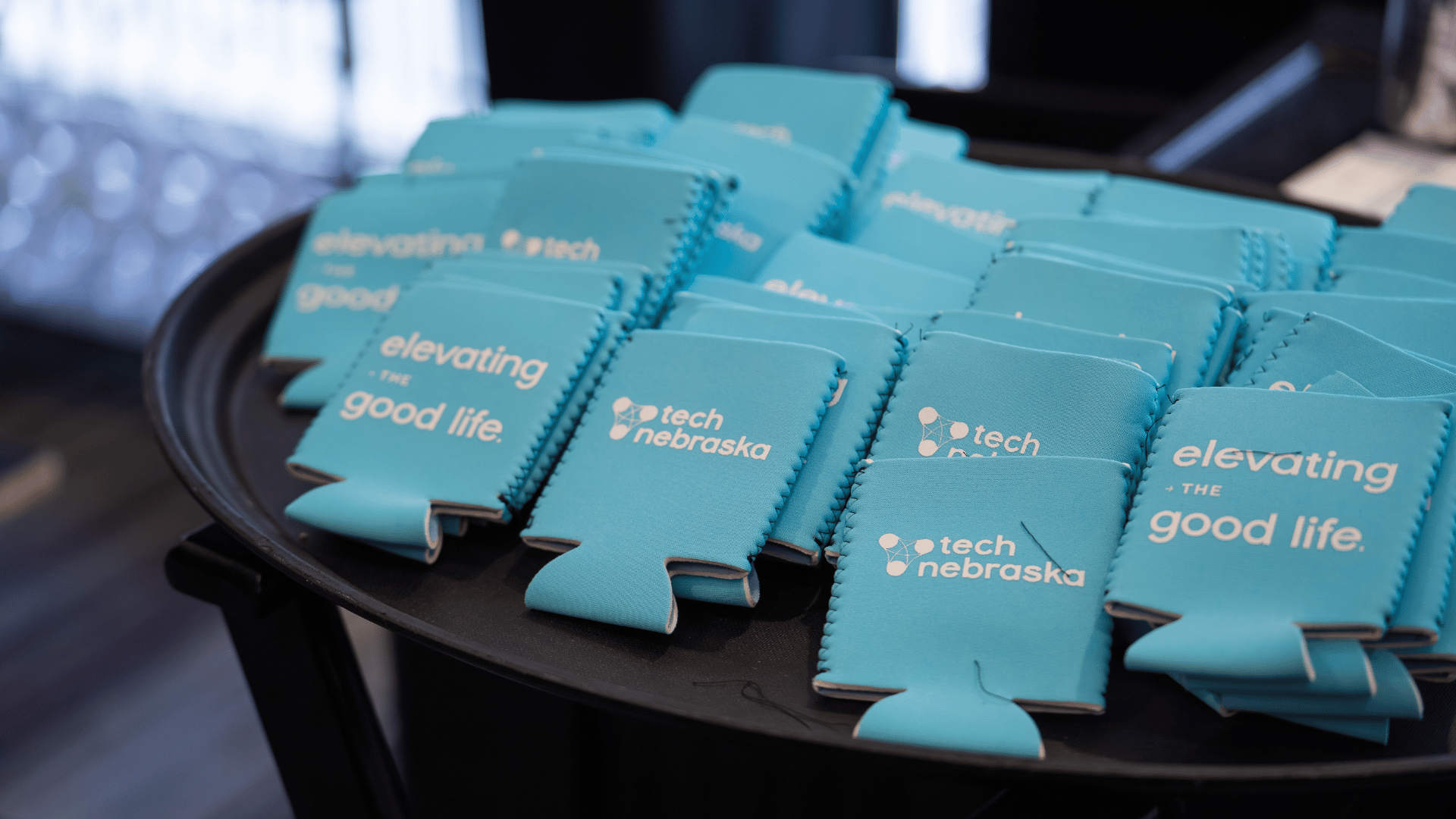 Tray of Tech Nebraska elevating the good life koozies