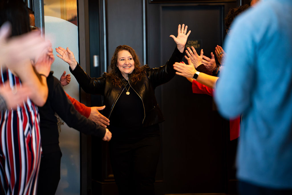 Guest raising both hands in a celebratory entrance