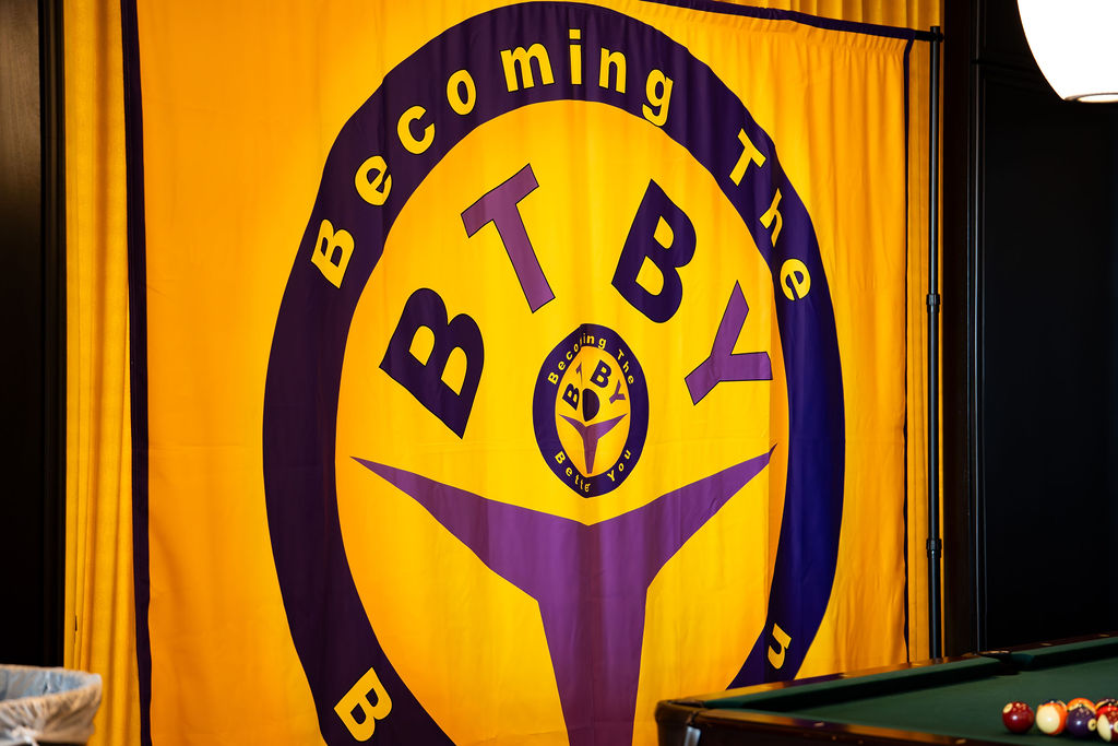 Giant Becoming the Better You banner hanging at the venue