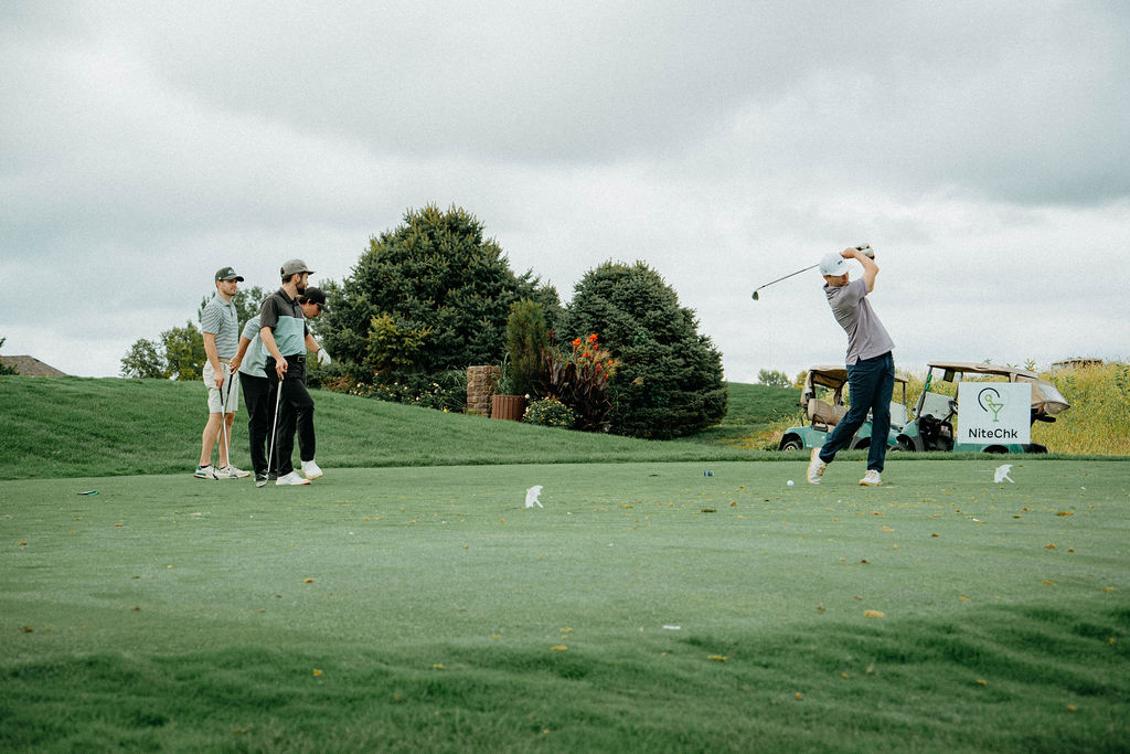 Tee shot with teammates watching