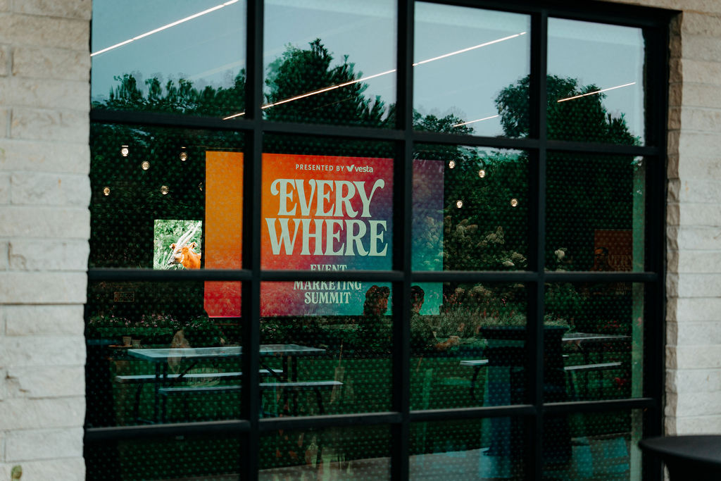EVERYWHERE screen reflected through the venue windows