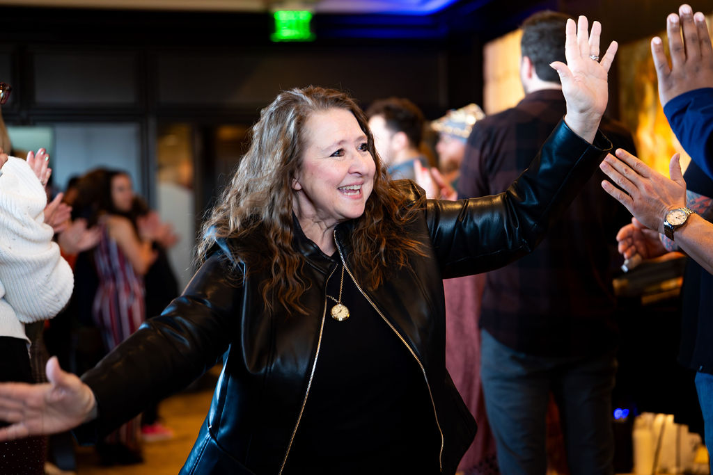 Attendee laughing while high-fiving guests