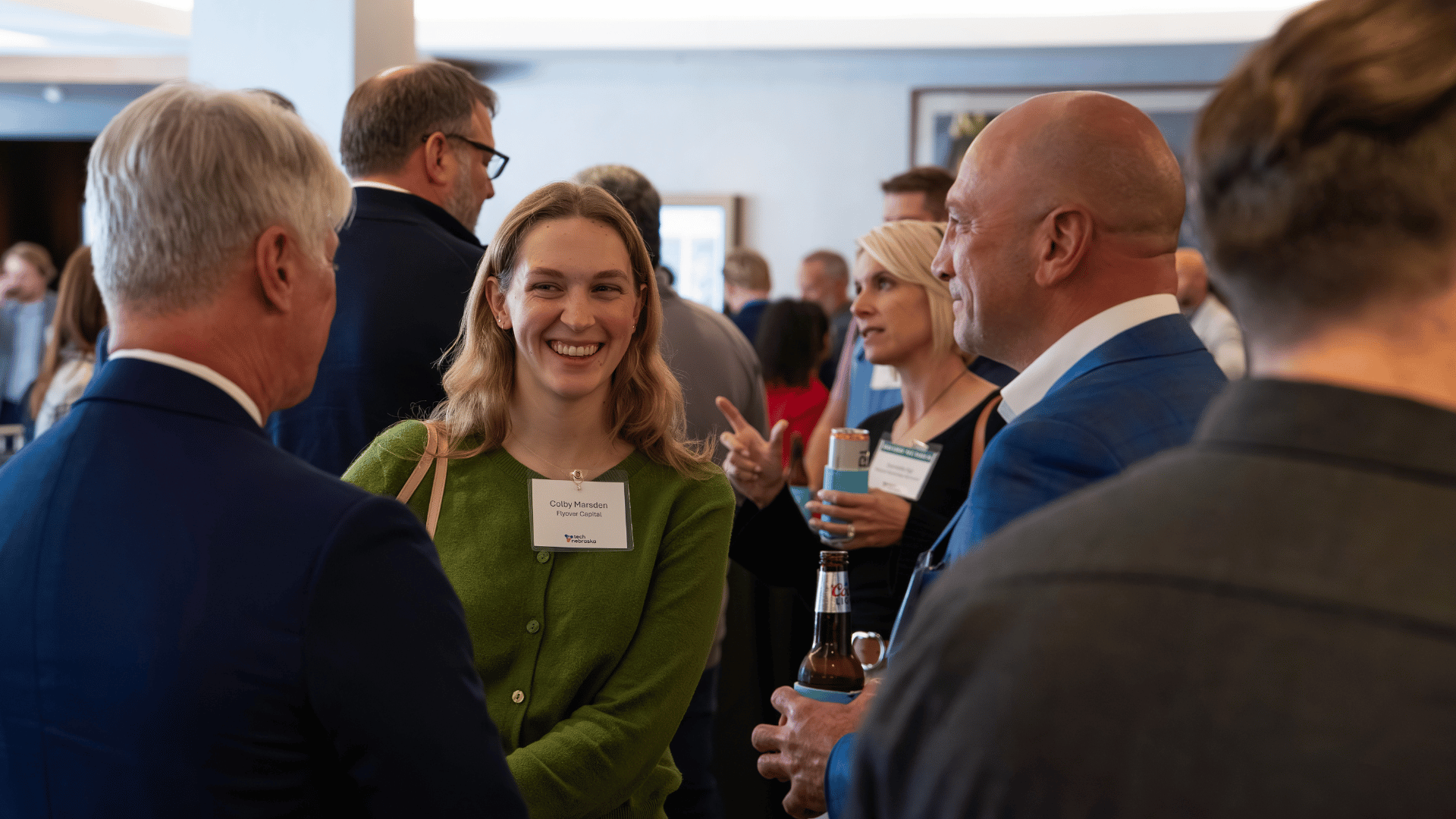 Attendees networking and laughing at the Tech Nebraska Summit