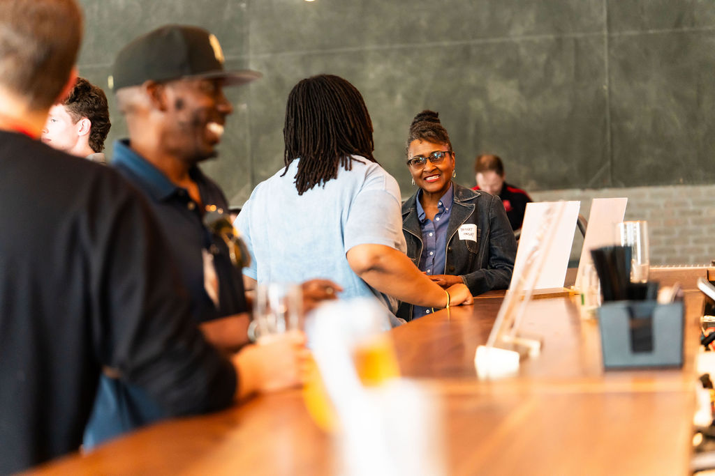 Attendees meeting at the bar on the first night
