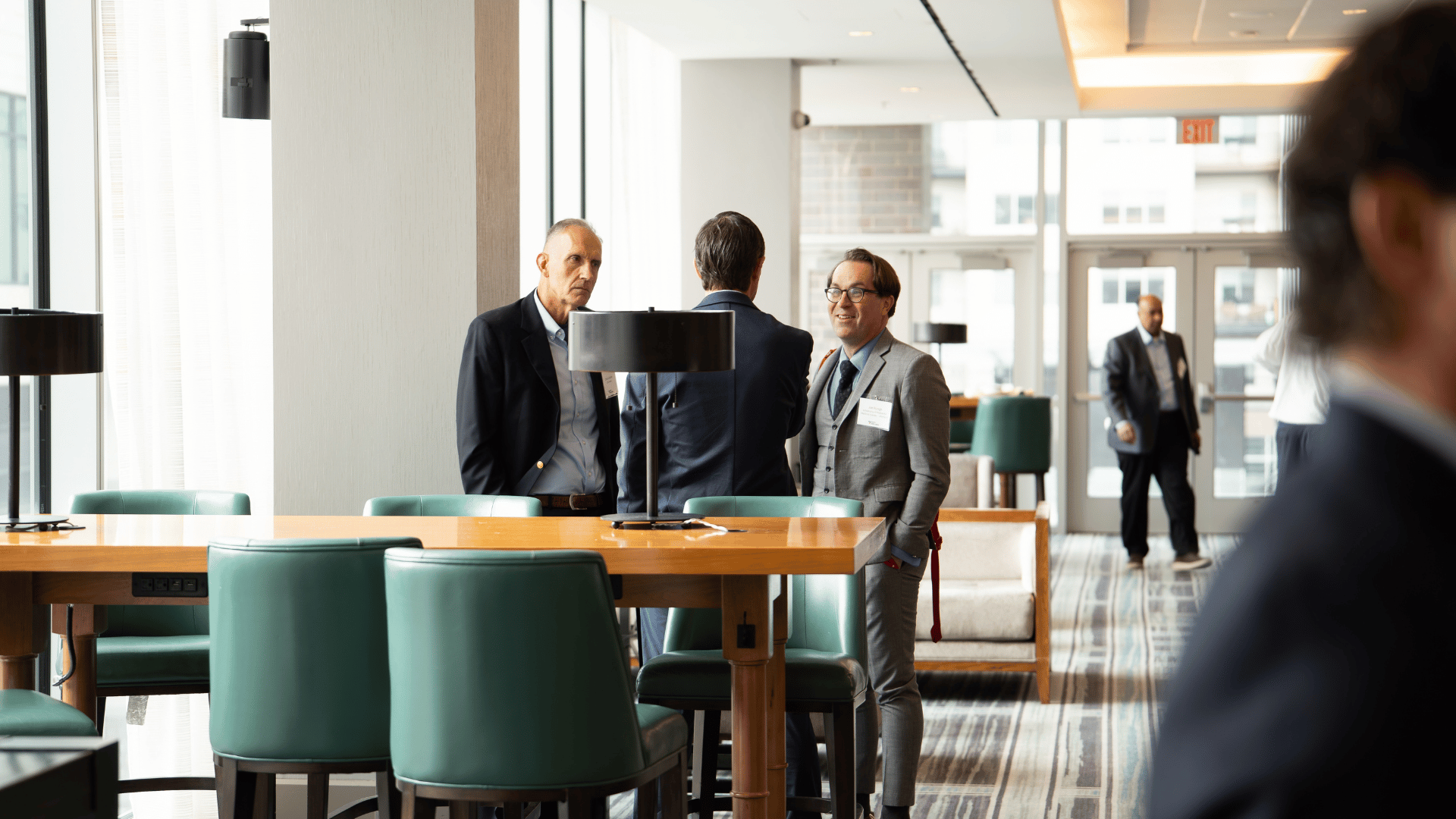 Attendees chatting in the lounge between sessions